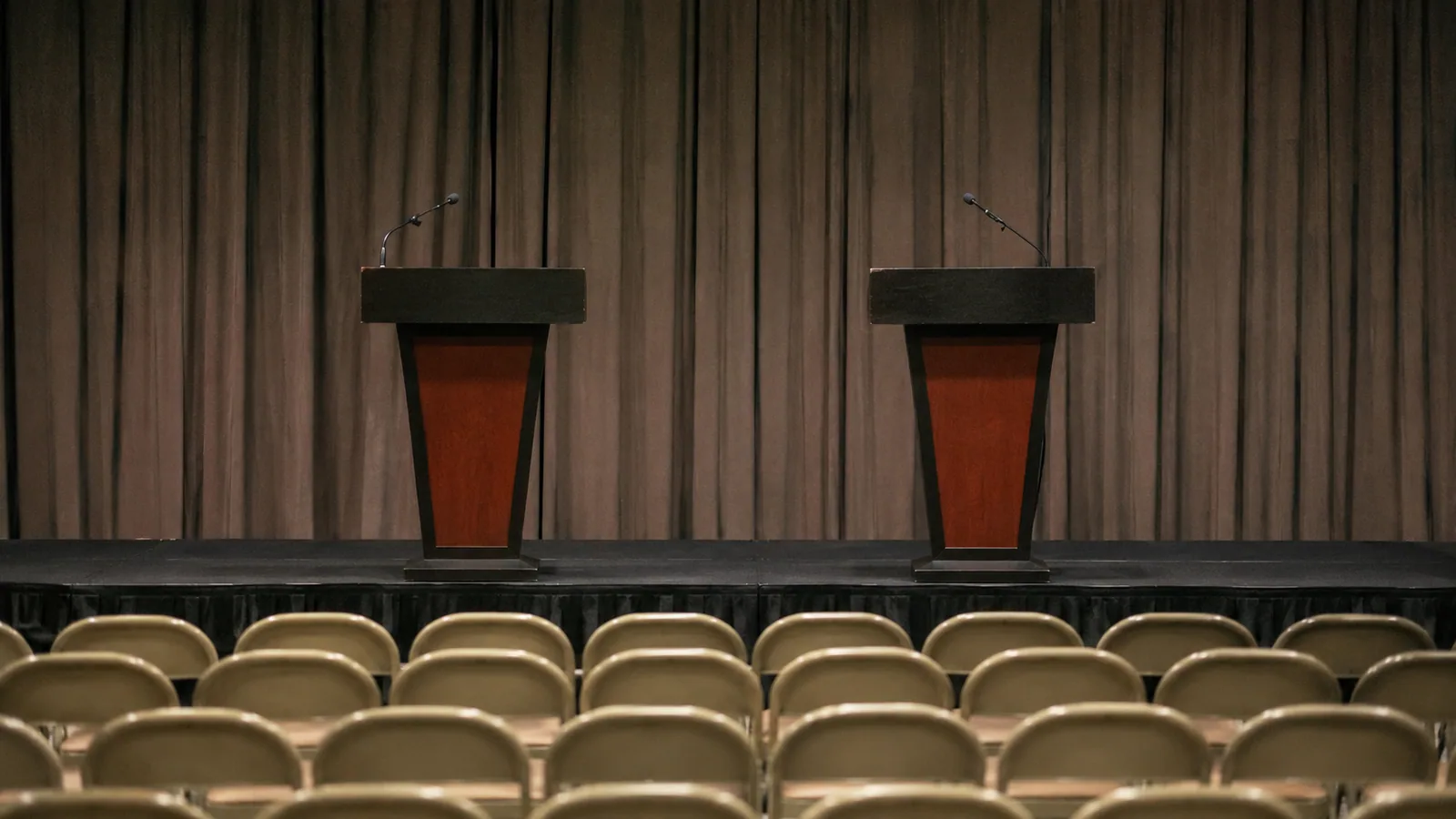 Two empty podiums side by side — a stage waiting for round three