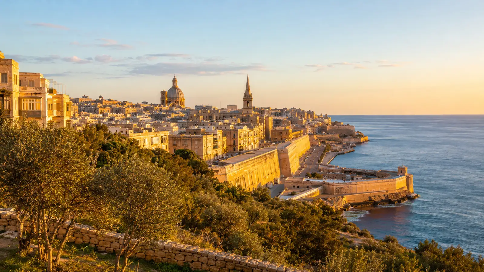 A Mediterranean coastal city from a hillside in golden hour light
