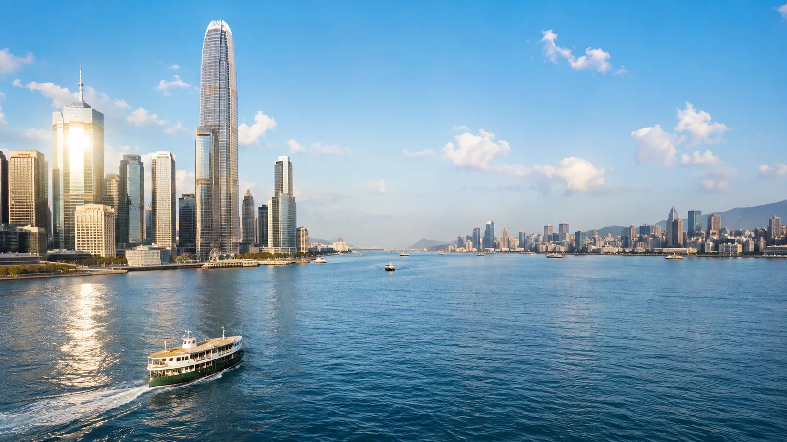 Two skylines across a harbour at midday