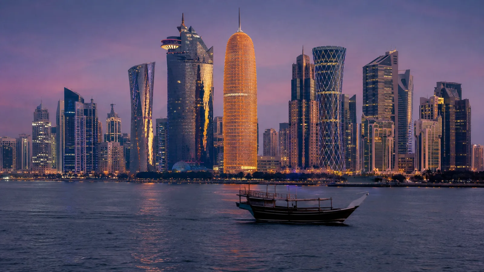 A Gulf skyline at dusk across the bay, a wooden boat crossing